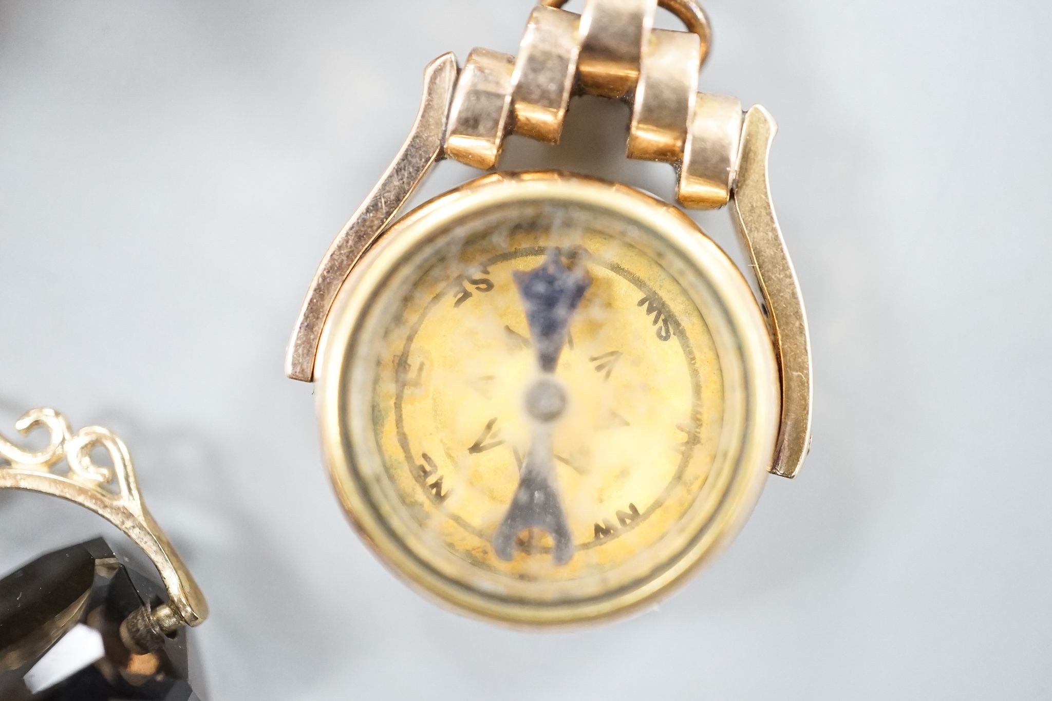 A modern 9ct gold mounted oval cameo shell brooch, 46mm, gross 16.4 grams, one other hardstone and split pearl set pendant brooch, a late Victorina 9ct spinning compass fob and two other items.